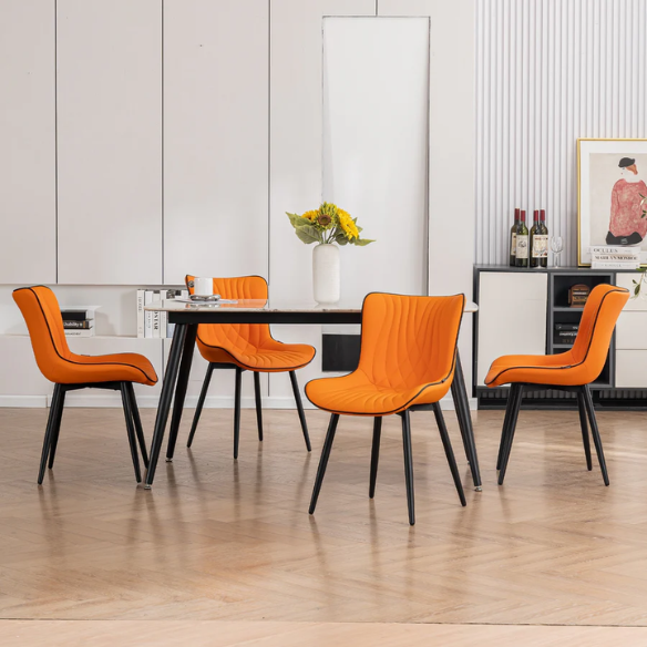 Set of 2 orange and black dining chairs with faux leather fishtail backs and metal legs, perfect for modern and contemporary interiors.

