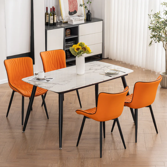 Set of 2 orange and black dining chairs with faux leather fishtail backs and metal legs, perfect for modern and contemporary interiors.

