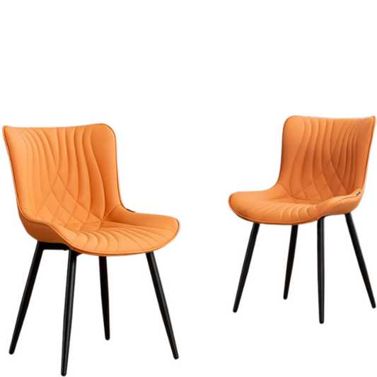 Set of 2 orange faux leather dining chairs with fishtail tufted backs and black metal legs, perfect for modern and colorful dining room settings.

