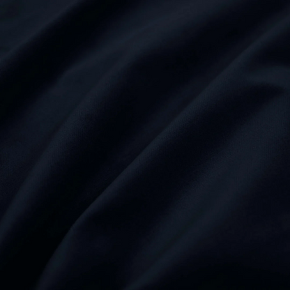 Royal blue king-size upholstered bed in velvet fabric with wingback headboard and low-profile black metal legs.

