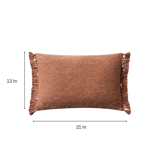 Rust-colored rectangular lumbar throw pillow with fringe trim, 13x21 inches, featuring a cotton-polyester-rayon cover and plush polyester fill—ideal for modern or boho home décor.

