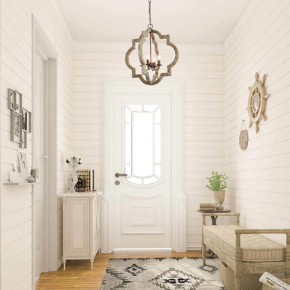Rustic distressed wood and iron quatrefoil chandelier with candle-style lights and adjustable chain, ideal for farmhouse or French country interiors.


