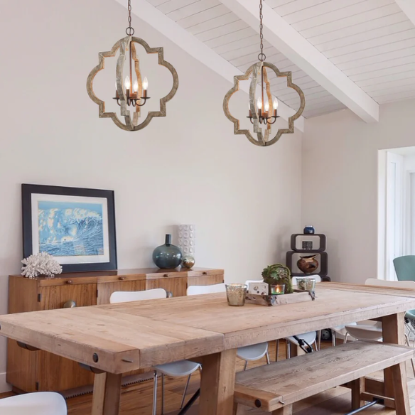Rustic distressed wood and iron quatrefoil chandelier with candle-style lights and adjustable chain, ideal for farmhouse or French country interiors.

