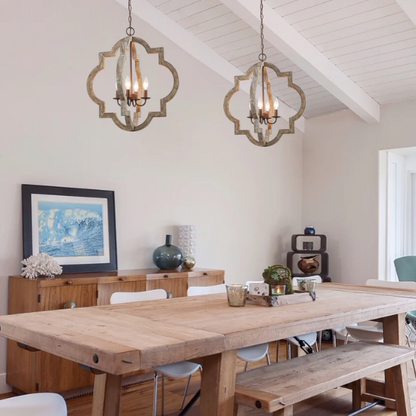 Rustic distressed wood and iron quatrefoil chandelier with candle-style lights and adjustable chain, ideal for farmhouse or French country interiors.

