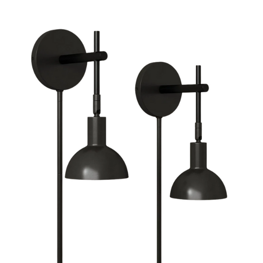 Set of 2 matte black plug-in wall sconces with adjustable swing arms and bell-shaped shades, ideal for bedside reading or task lighting in modern interiors.
