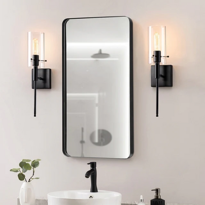 Set of 2 black wall sconces with hand-blown glass cylinder shades and bronze hardware, mountable up or down for modern or farmhouse interiors

