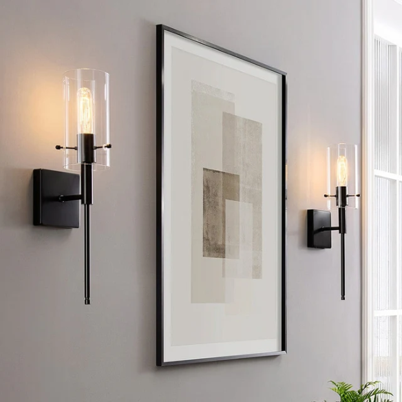 Set of 2 black wall sconces with hand-blown glass cylinder shades and bronze hardware, mountable up or down for modern or farmhouse interiors

