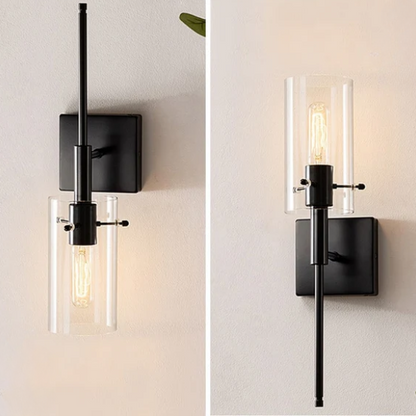 Set of 2 black wall sconces with hand-blown glass cylinder shades and bronze hardware, mountable up or down for modern or farmhouse interiors

