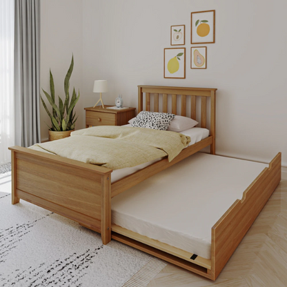 Modern solid wood twin bed with pull-out trundle in pecan finish, featuring slatted headboard and footboard – perfect for kids' rooms and sleepovers.