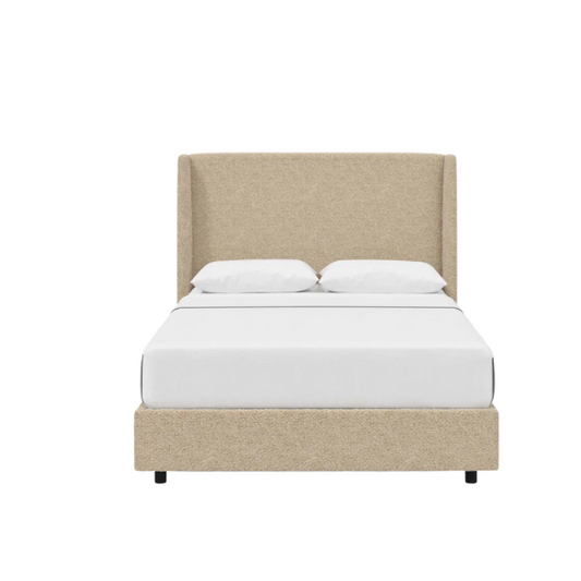 Tan king-size upholstered bed in bouclé fabric with wingback headboard and low-profile black metal legs.

