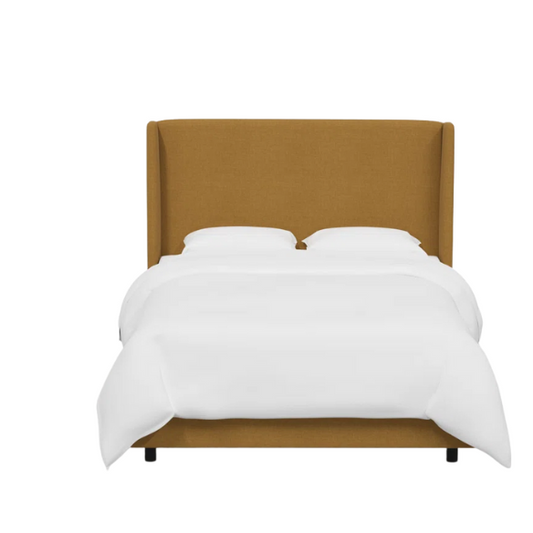Warm golden king-size upholstered bed in linen fabric with wingback headboard and black metal legs.


