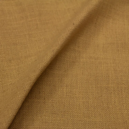 Warm golden king-size upholstered bed in linen fabric with wingback headboard and black metal legs.


