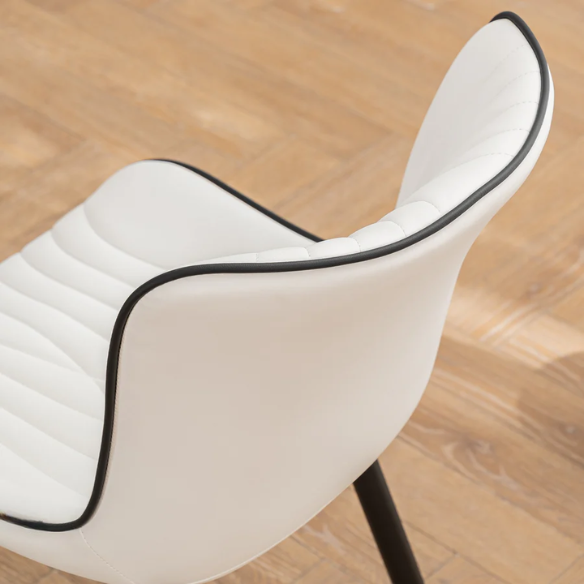 Set of 2 modern dining chairs with white faux leather upholstery and black metal fishtail-style backs, perfect for contemporary kitchens and dining rooms.

