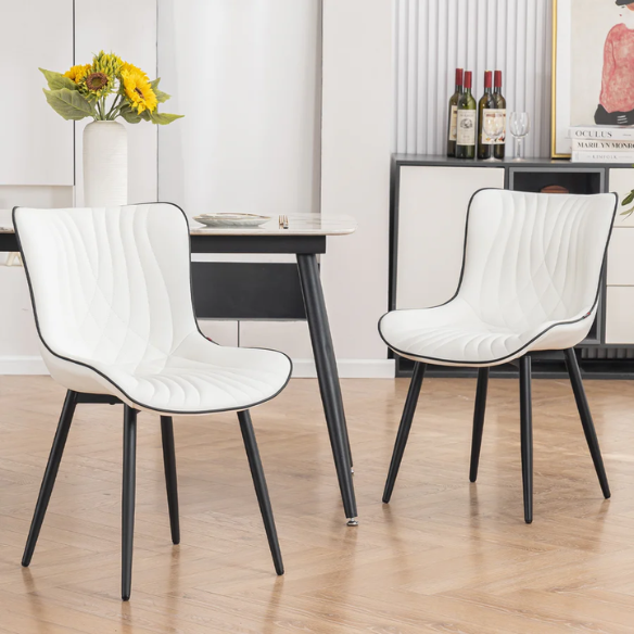 Set of 2 modern dining chairs with white faux leather upholstery and black metal fishtail-style backs, perfect for contemporary kitchens and dining rooms.

