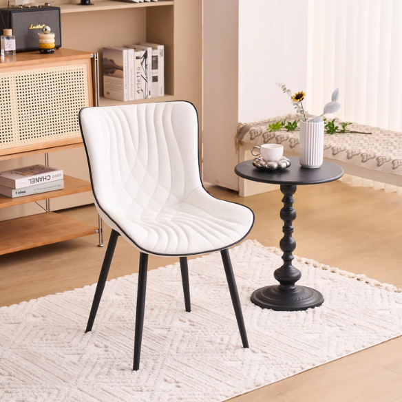 Set of 2 modern dining chairs with white faux leather upholstery and black metal fishtail-style backs, perfect for contemporary kitchens and dining rooms.

