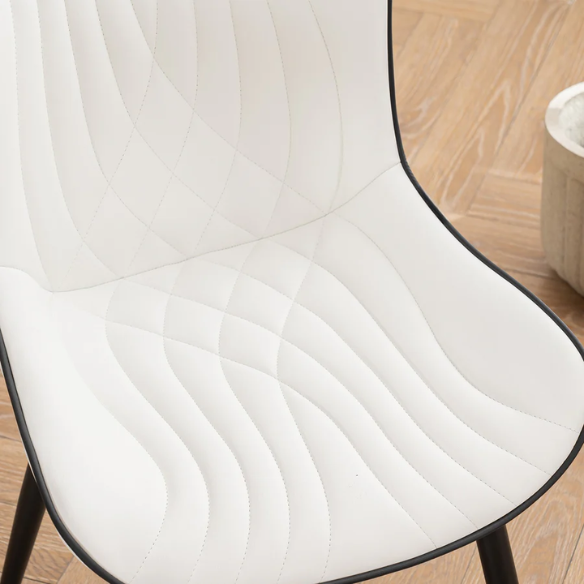 Set of 2 modern dining chairs with white faux leather upholstery and black metal fishtail-style backs, perfect for contemporary kitchens and dining rooms.

