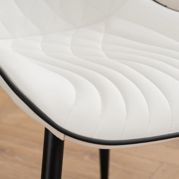 Set of 2 modern dining chairs with white faux leather upholstery and black metal fishtail-style backs, perfect for contemporary kitchens and dining rooms.

