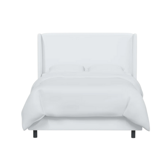 White king-size upholstered bed in twill fabric with wingback headboard and low-profile black metal legs.

