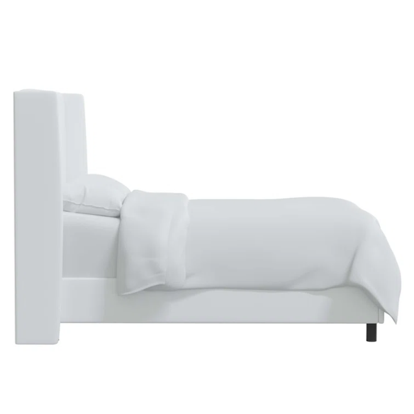 White king-size upholstered bed in twill fabric with wingback headboard and low-profile black metal legs.

