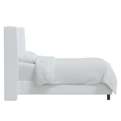 White king-size upholstered bed in twill fabric with wingback headboard and low-profile black metal legs.

