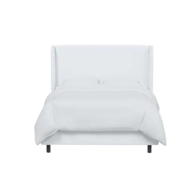 White king-size upholstered bed in velvet fabric with wingback headboard and low-profile black metal legs.

