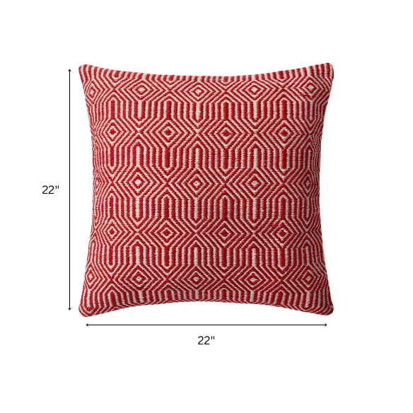 Red and cream geometric throw pillow on modern outdoor furniture with vibrant decor


