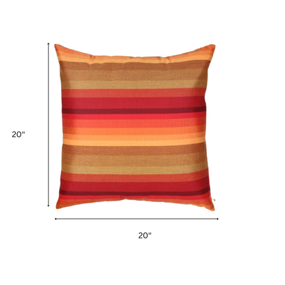 Striped accent pillow in red, orange, and brown – reversible, weather-resistant, and overstuffed for cozy indoor or outdoor décor.


