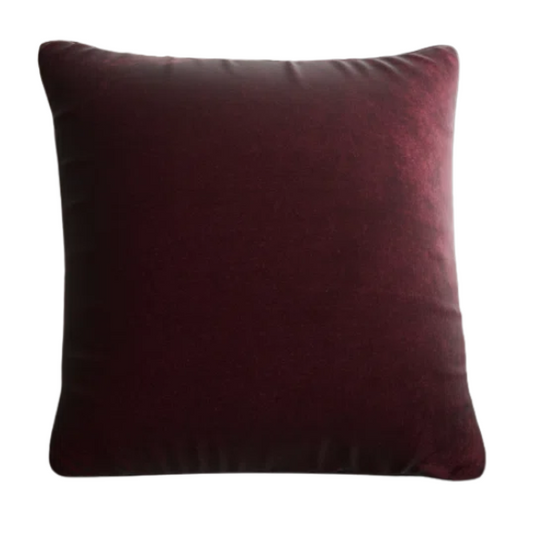 Red wine crushed velvet throw pillow, 16x16 square with soft, reversible fabric and hidden zipper, styled on a modern sofa for a sophisticated touch.

