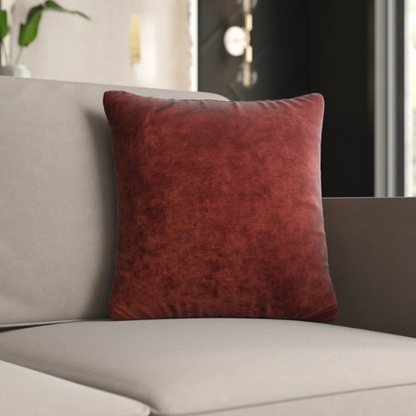Rust crushed velvet throw pillow, 16x16 square design with soft texture and reversible fabric, styled on a modern sofa for cozy and elegant home decor.

