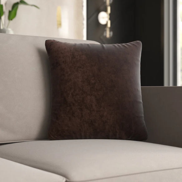 Rust crushed velvet throw pillow, 16x16 square design with soft texture and reversible fabric, styled on a modern sofa for cozy and elegant home decor.

