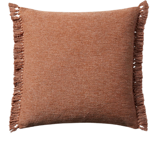 Rust cotton blend throw pillow with fringe, 22x22 square decorative cushion styled on a neutral-toned sofa for cozy, modern home décor.

