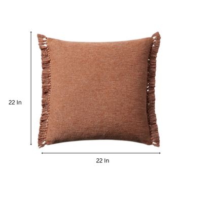 Rust cotton blend throw pillow with fringe, 22x22 square decorative cushion styled on a neutral-toned sofa for cozy, modern home décor.

