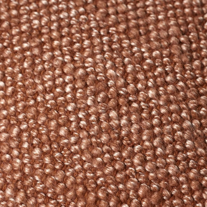 Rust cotton blend throw pillow with fringe, 22x22 square decorative cushion styled on a neutral-toned sofa for cozy, modern home décor.

