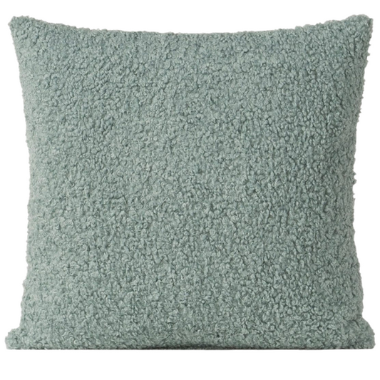 Seafoam green bouclé throw pillow with soft looped texture, square accent pillow on a neutral sofa


