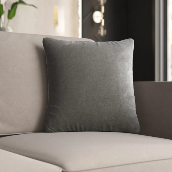 Silver crushed velvet throw pillow, 16x16 square with soft, reversible fabric and hidden zipper, styled on a modern sofa for a sleek, elegant look.

