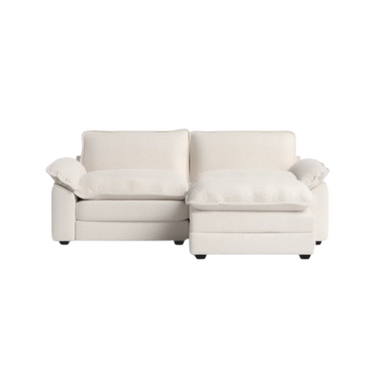 Soft warm cream modular cloud sofa with deep foam cushions, pillow top arms, and a matching free-standing ottoman