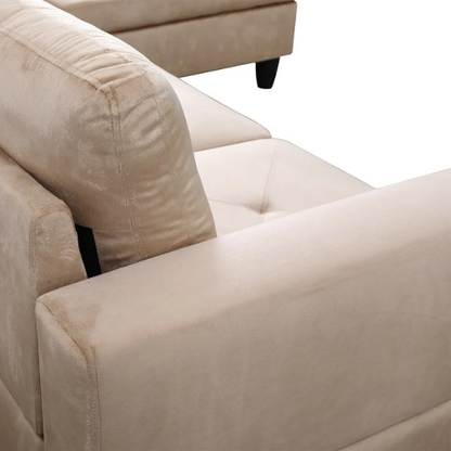 Tan L-shaped sectional sofa with right-facing chaise and ottoman, microfiber upholstery and light gray wooden legs