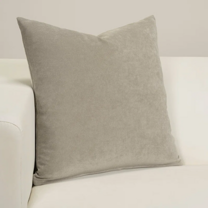 Taupe crushed velvet throw pillow, 16x16 square design with soft texture and reversible fabric, styled on a modern sofa for cozy, neutral home decor.

