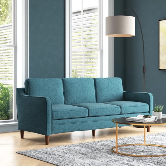 Teal chenille upholstered sofa with curved track arms, soft foam cushions, and tapered wooden legs in a mid-century modern style.