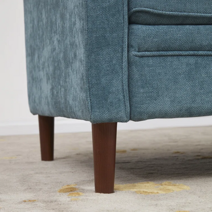 Teal chenille upholstered sofa with curved track arms, soft foam cushions, and tapered wooden legs in a mid-century modern style.