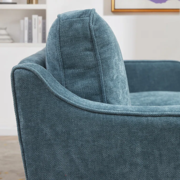 Teal chenille upholstered sofa with curved track arms, soft foam cushions, and tapered wooden legs in a mid-century modern style.
