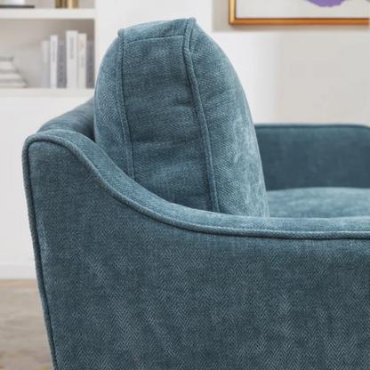 Teal chenille upholstered sofa with curved track arms, soft foam cushions, and tapered wooden legs in a mid-century modern style.