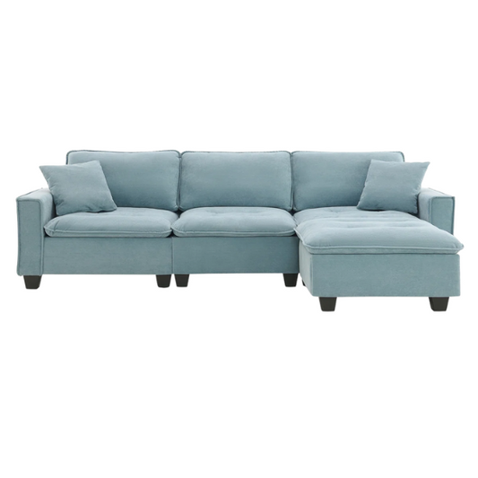 Tranquil sea blue suede L-shaped sectional sofa with tufted seat cushions, reversible chaise, removable ottoman, and two matching throw pillows