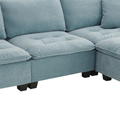 Tranquil sea blue suede L-shaped sectional sofa with tufted seat cushions, reversible chaise, removable ottoman, and two matching throw pillows