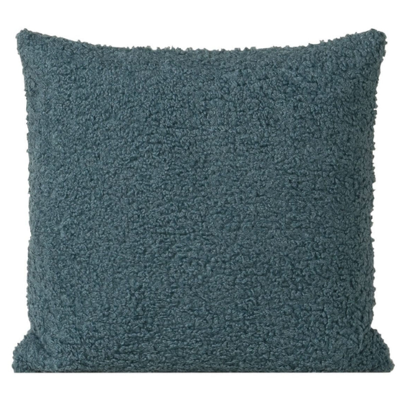 Turquoise bouclé throw pillow with textured loop fabric, square accent pillow on a modern sofa


