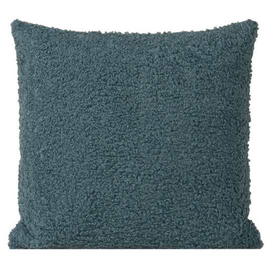 Turquoise bouclé throw pillow with textured loop fabric, square accent pillow on a modern sofa



