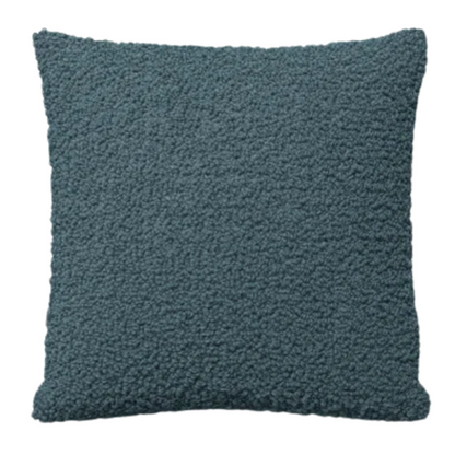 Turquoise bouclé throw pillow with textured loop fabric, square accent pillow on a modern sofa

