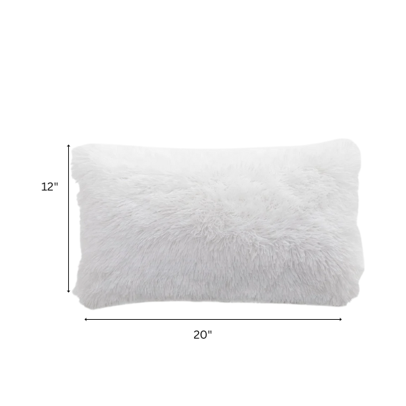 Set of two white faux fur throw pillows with fluffy texture on a modern neutral-toned couch

