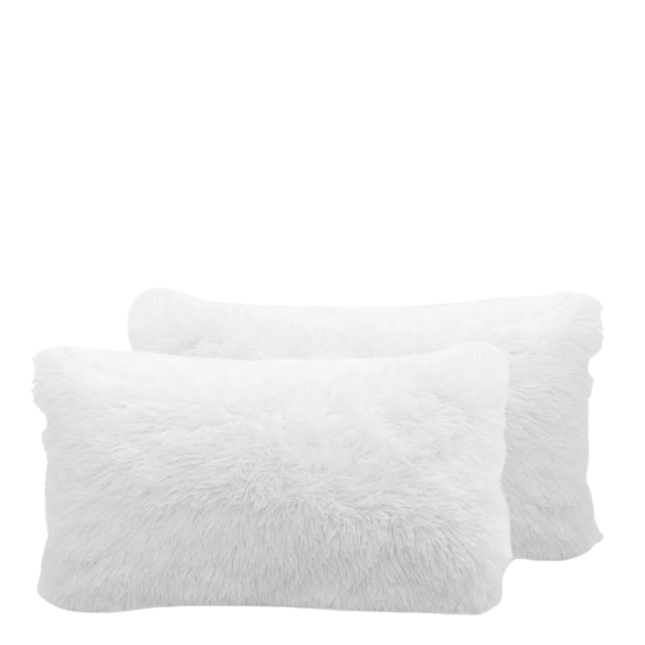 Set of two white faux fur throw pillows with fluffy texture on a modern neutral-toned couch

