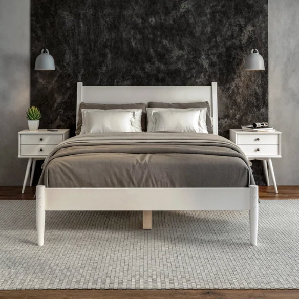 White full-size mid-century modern solid wood platform bed with tapered legs and rectangular headboard